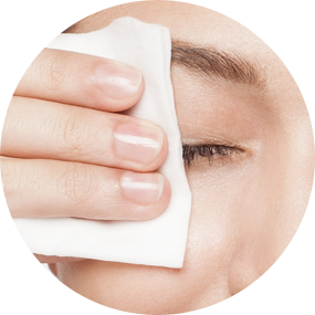 closeup of a woman wiping her eye with a pad