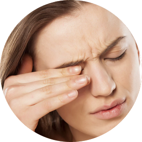 Woman rubbing her eyes with one hand as if tired
