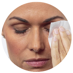 woman wiping her eyes with a makeup removal cloth