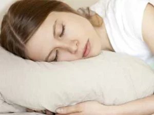 woman asleep on a big fluffy pillow